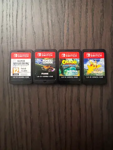 Set of 4 Nintendo Switch game cartridges  Pokémon, Super Smash Bros, Rocket League & Crash Bandicoot