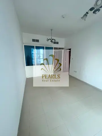 One-bedroom apartment with a living room available for annual rent in City Tower, Al Nuaimiya 3, Ajman. It features a closed kitchen and two bathrooms