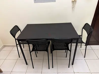 Black dining table with 4 matching chairs - sturdy compact set