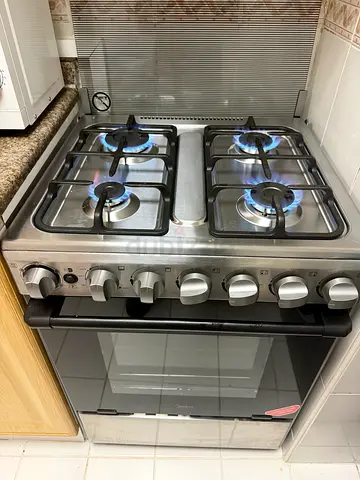 Used stainless steel 4-burner gas stove with oven - good condition