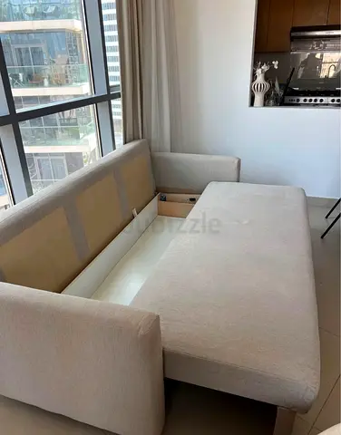Light beige fabric sofa bed with storage - good condition