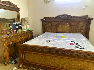 Solid carved wooden king size bed with matching dresser and mirror