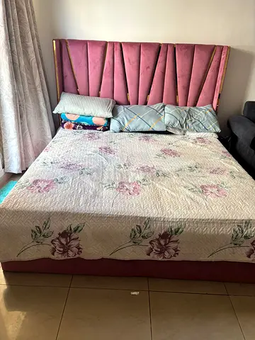 King size upholstered bed with pink velvet headboard