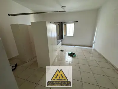 Spacious studio in Al Rashidiya 3, opposite Ajman One. Semi-separated kitchen, built-in wardrobes, central AC. AED 18,005 yearly. Payable in 4 or 6 in