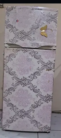 Small double-door refrigerator in working condition — floral cover