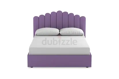 Purple upholstered double bed with scalloped headboard