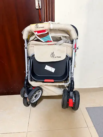 Lightly used beige baby stroller (folds) - good condition