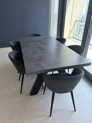 Modern dark grey dining table with 6 quilted chairs
