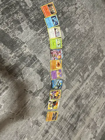 Lot of 12 Pokémon Trading Cards - Mixed Common & Holo and all of the cards is 15 AED