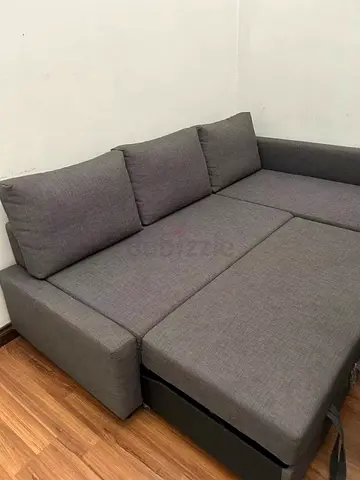 Grey L-shaped sofa bed with storage - good condition