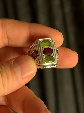 Silver men's ring with green peridot and central red stone
