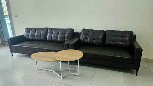 Two black leather sofas (3-seater) with nesting coffee tables