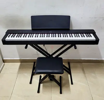 The Yamaha P225B is an 88-key compact, portable digital piano featuring a black finish, weighted