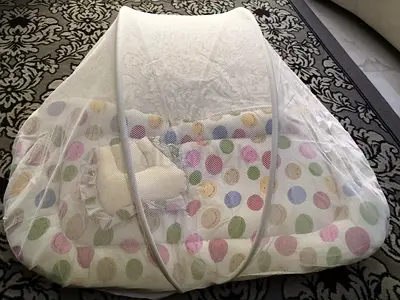 Portable baby bed with mosquito net and padded mattress and cushion