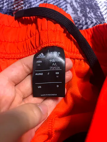 Adidas orange athletic shorts, size A/L (170/92A) — good condition