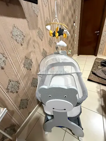 Light grey baby bassinet with mobile - good condition