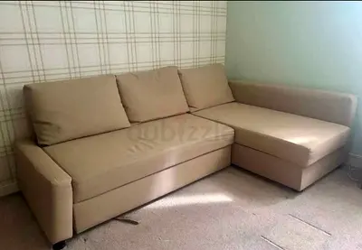 Beige L-shaped Sofa Bed with Storage — Good Condition