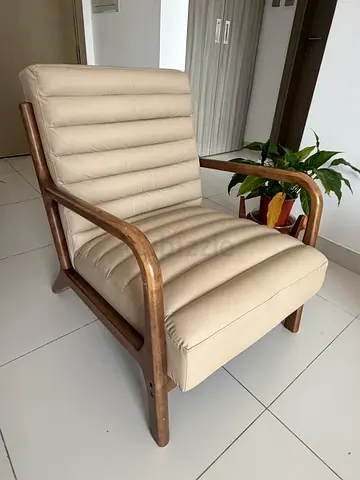 Beige Padded Lounge Chair with Wooden Frame - Good Condition