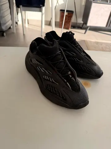 Used black Yeezy-style sneakers, size not specified, good condition