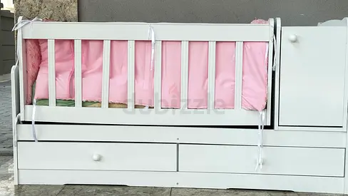 White convertible baby crib with drawers and attached changer