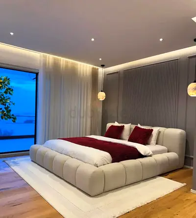 Modern low-profile upholstered king bed with padded headboard - cream