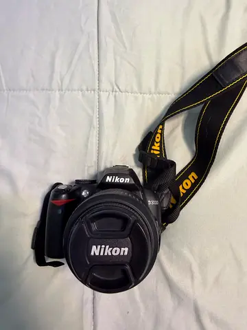 Nikon DSLR camera with strap and lens cap - used