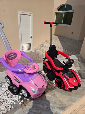 Set of 2 kids ride-on cars with push handle — pink and red