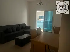 Furnished one-bedroom apartment with a living room and private parking in City Tower – Ajman; an e