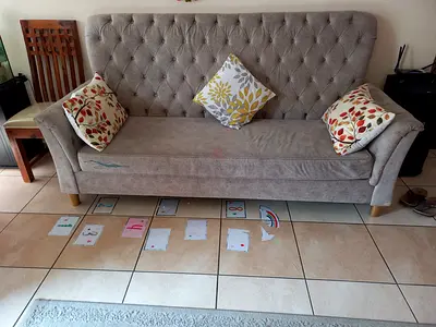 Light grey tufted 3-4  seater sofa in good condition