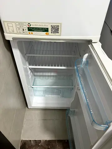 Small white top-freezer fridge in good working condition