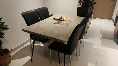 Good condition dining table from Home Box with 4 black leather chairs