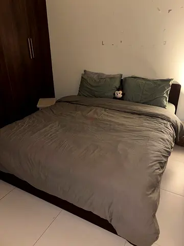 Queen size bed with mattress and grey bedding