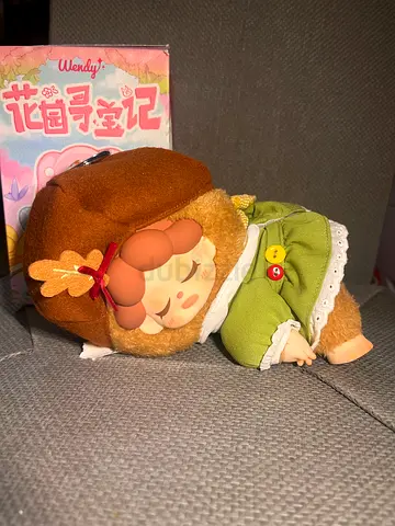 Cute plush doll in green outfit — gently used