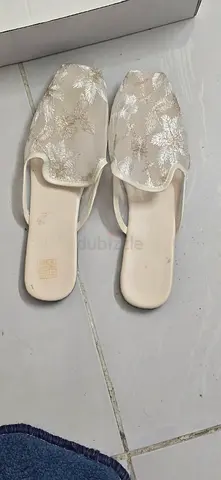 Pair of cream embroidered women's slip-on sandals, gently used