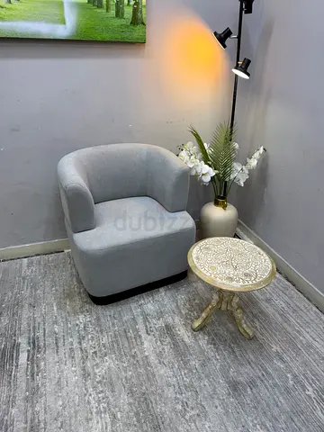 Light grey upholstered accent chair in good condition