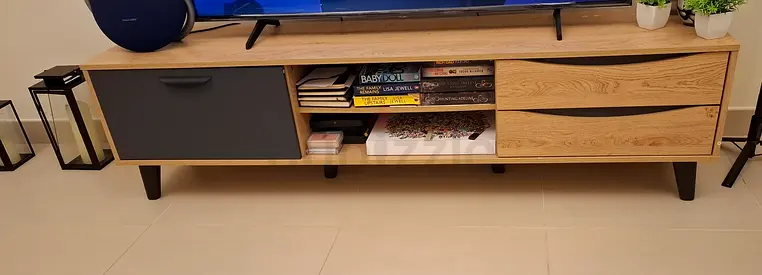Low-profile wooden TV unit with storage drawers and open shelves