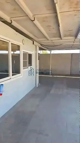 For rent: a plot (hawta) in Old Al Sajaa, second line from the Emirates Transit Road (Al-Abir Road), featuring paved road access on both the front and