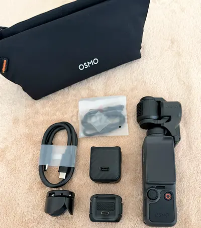 DJI Osmo Pocket 4 with accessories and pouch - good condition like new.
