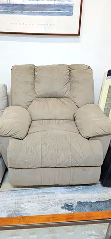Comfortable beige recliner armchair in good used condition