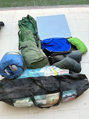 Used camping gear bundle — sleeping bags, mats and carry bags