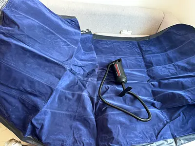 Used Blue Inflatable Air Mattress with Hand Pump