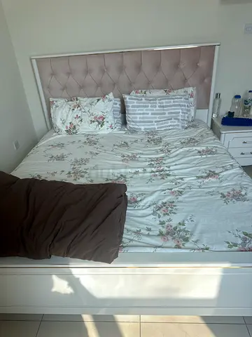 Queen bed frame with upholstered tufted headboard and mattress - white along with dressing