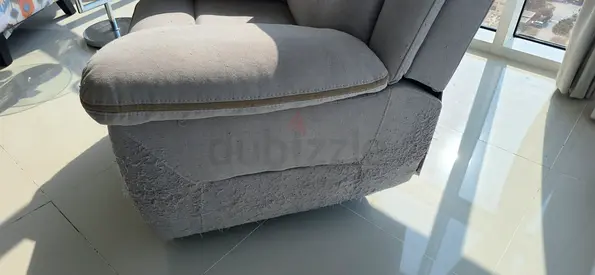 Light grey fabric single-seater armchair. Hardly used, but damaged by a cat.