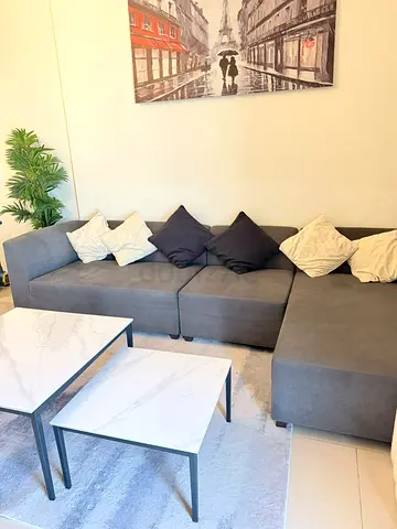 Grey L-shaped Fabric Sofa with Ottoman — Good Condition