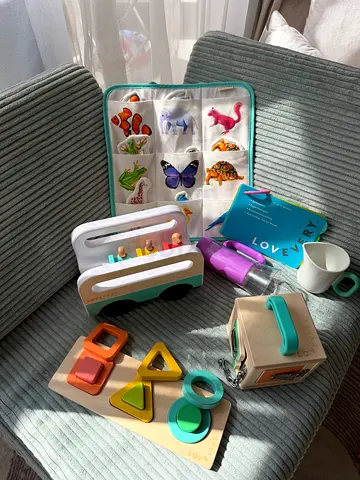 Set of wooden and activity toys for toddler - shape sorter, popper, stacking toys