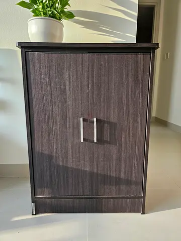 Dark wood storage cabinet with shelves