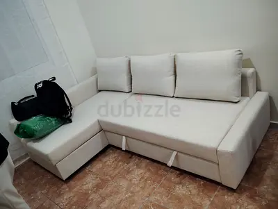 Light beige L-shaped sofa with storage - good condition