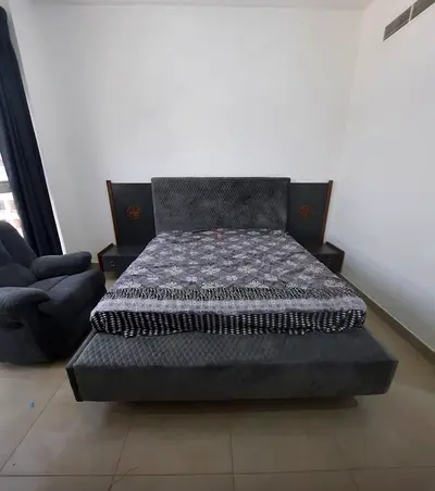 Grey kingsize Danube bed with integrated headboard and bedside tables with mattress