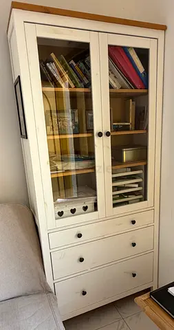 White IKEA HEMNES glass-door cabinet with 3 drawers.