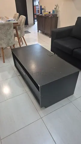 Used black wooden coffee table with storage — good condition
